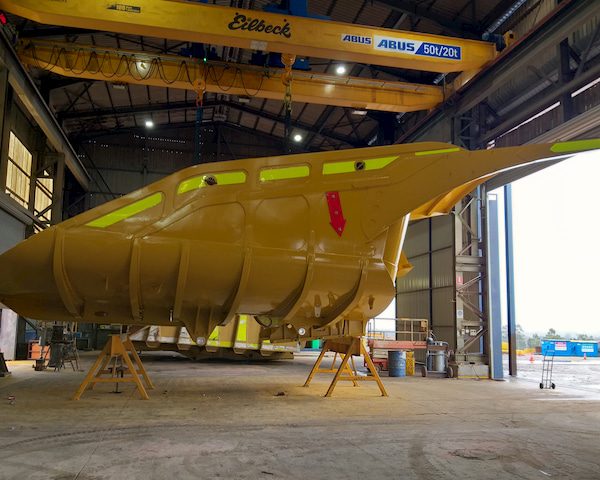 Yellow Haul truck body inside a warehouse